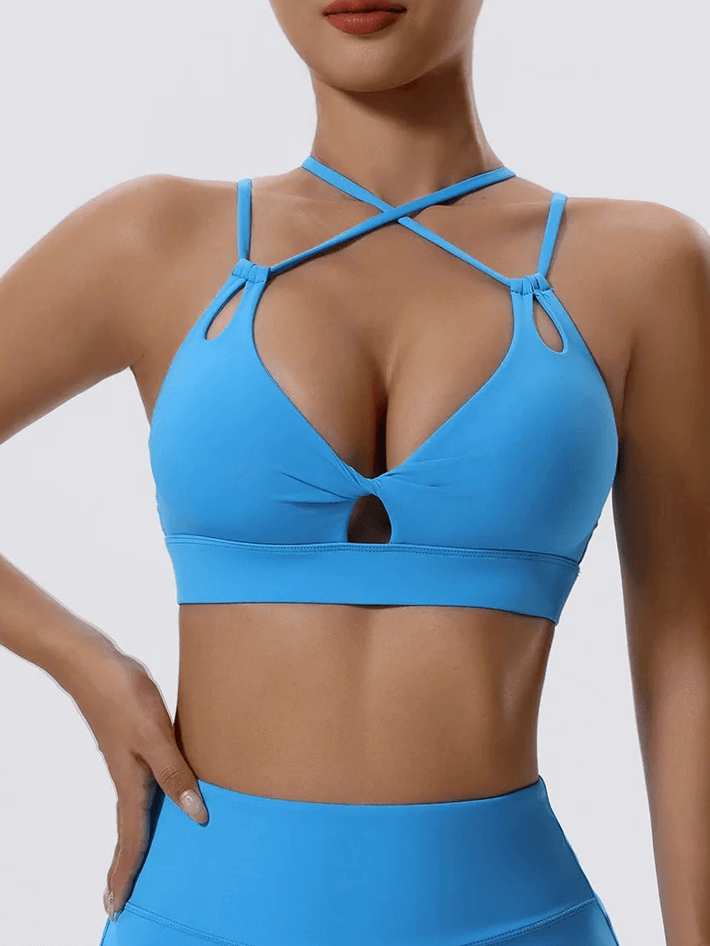 Blue strappy sports bra with cut-out details, perfect for workouts and casual wear, showcasing stylish design and secure fit.